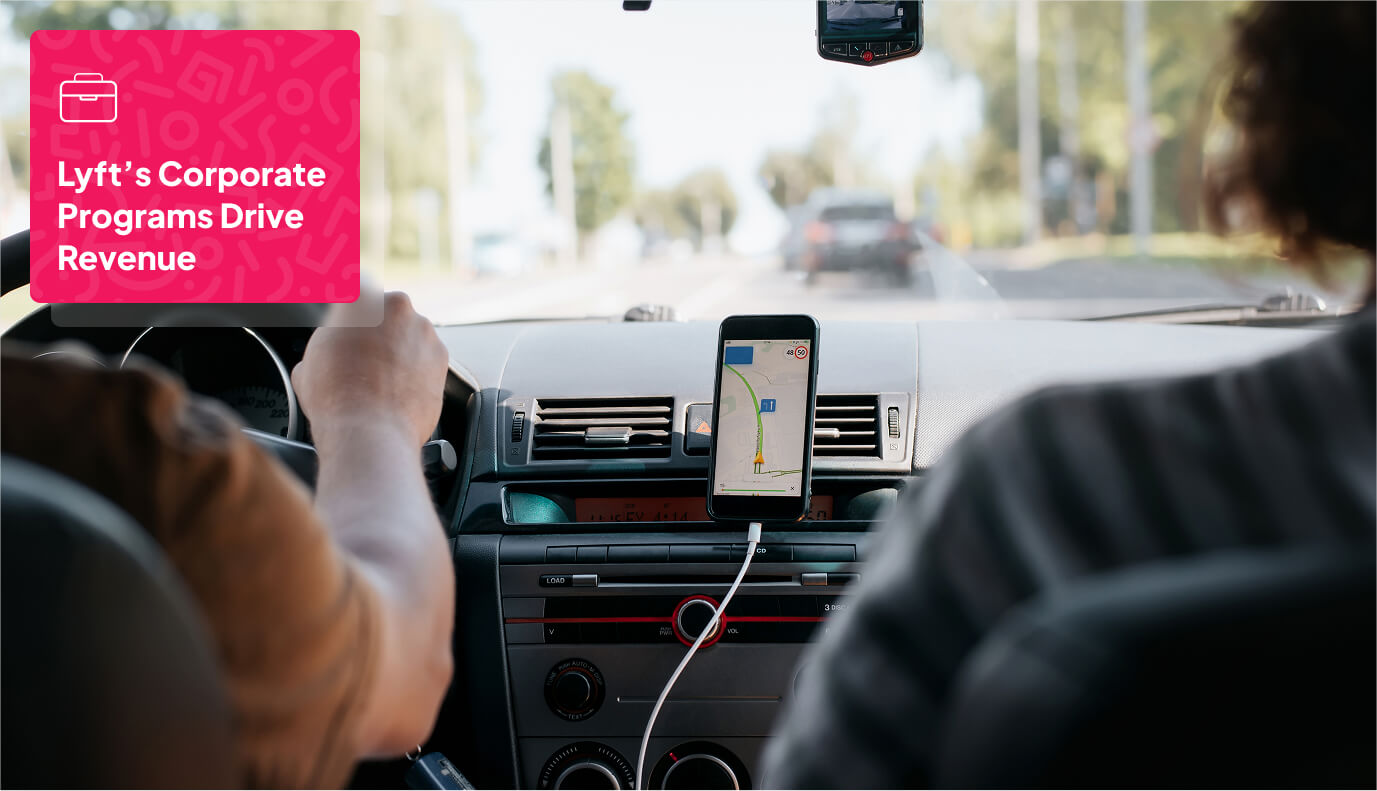 a person driving a car while using a smartphone mounted on the dashboard for navigation.