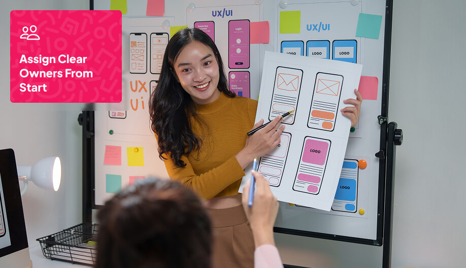 a woman showing a graphic mockups of screen designs