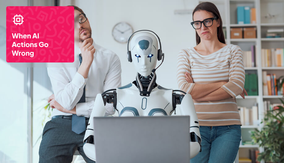 a humanoid robot working on a laptop with two humans at its back observing